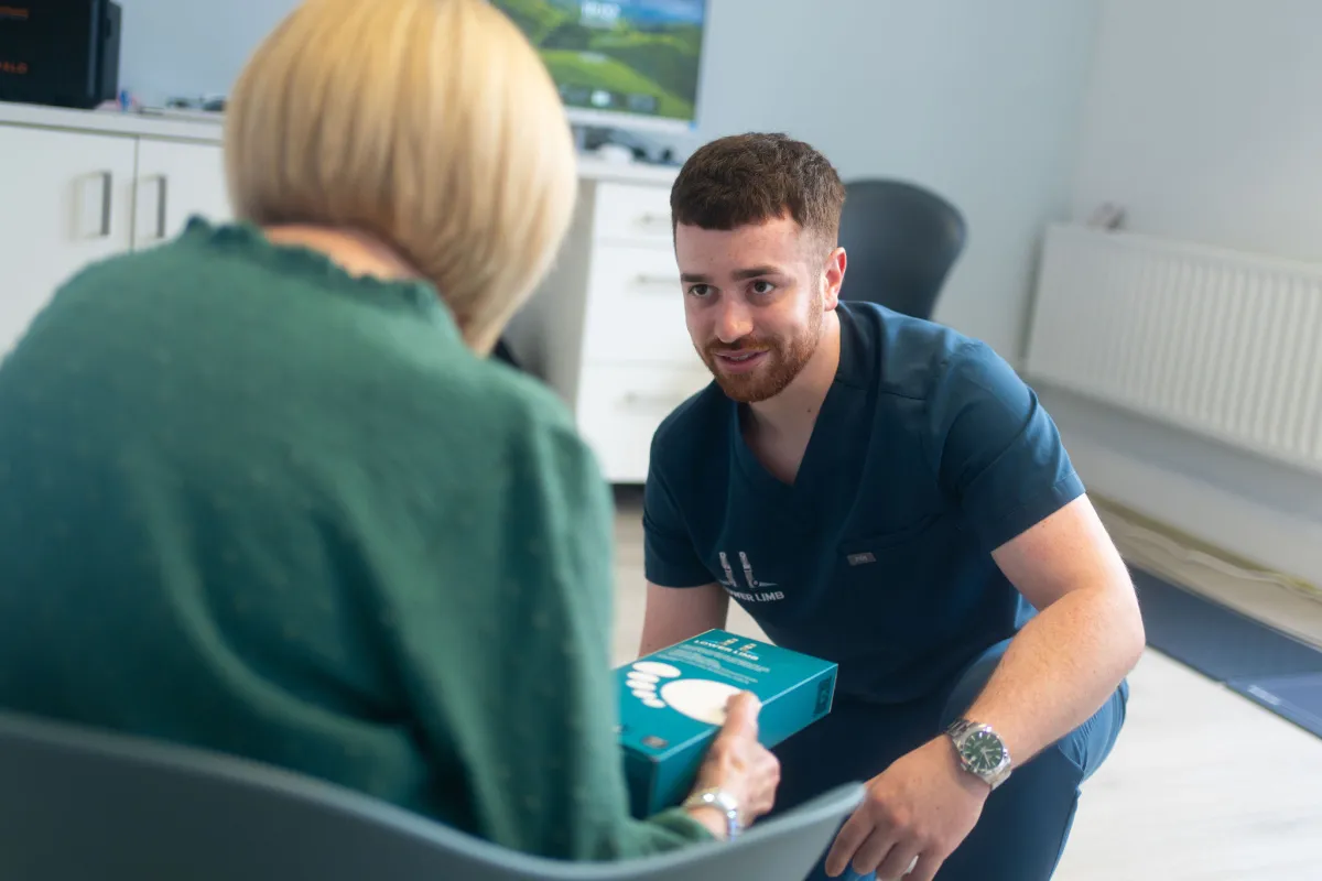 Paul McMullan, podiatrist, consulting with a golfer about foot pain and golf shoe biomechanics at Lower Limb Clinic Belfast