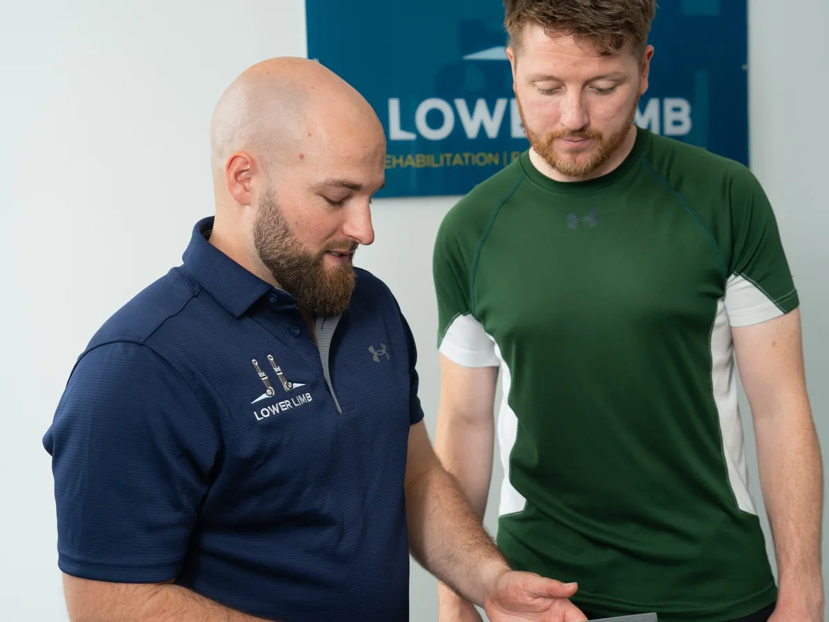 Physiotherapy assessment at Lower Limb Clinic Belfast, reviewing results together on an iPad